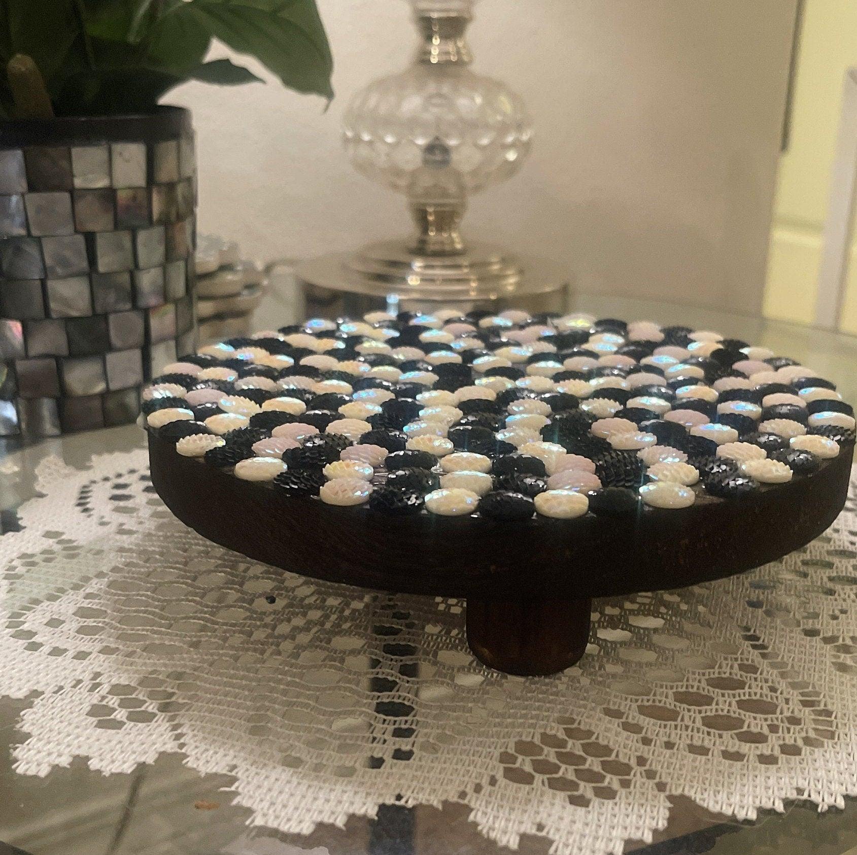 Handmade black and white iridescent mosaic plant stand with geometric design and sturdy base.