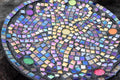 Original handcrafted iridescent mosaic wall art featuring colorful glass pieces in a vibrant, artistic display.