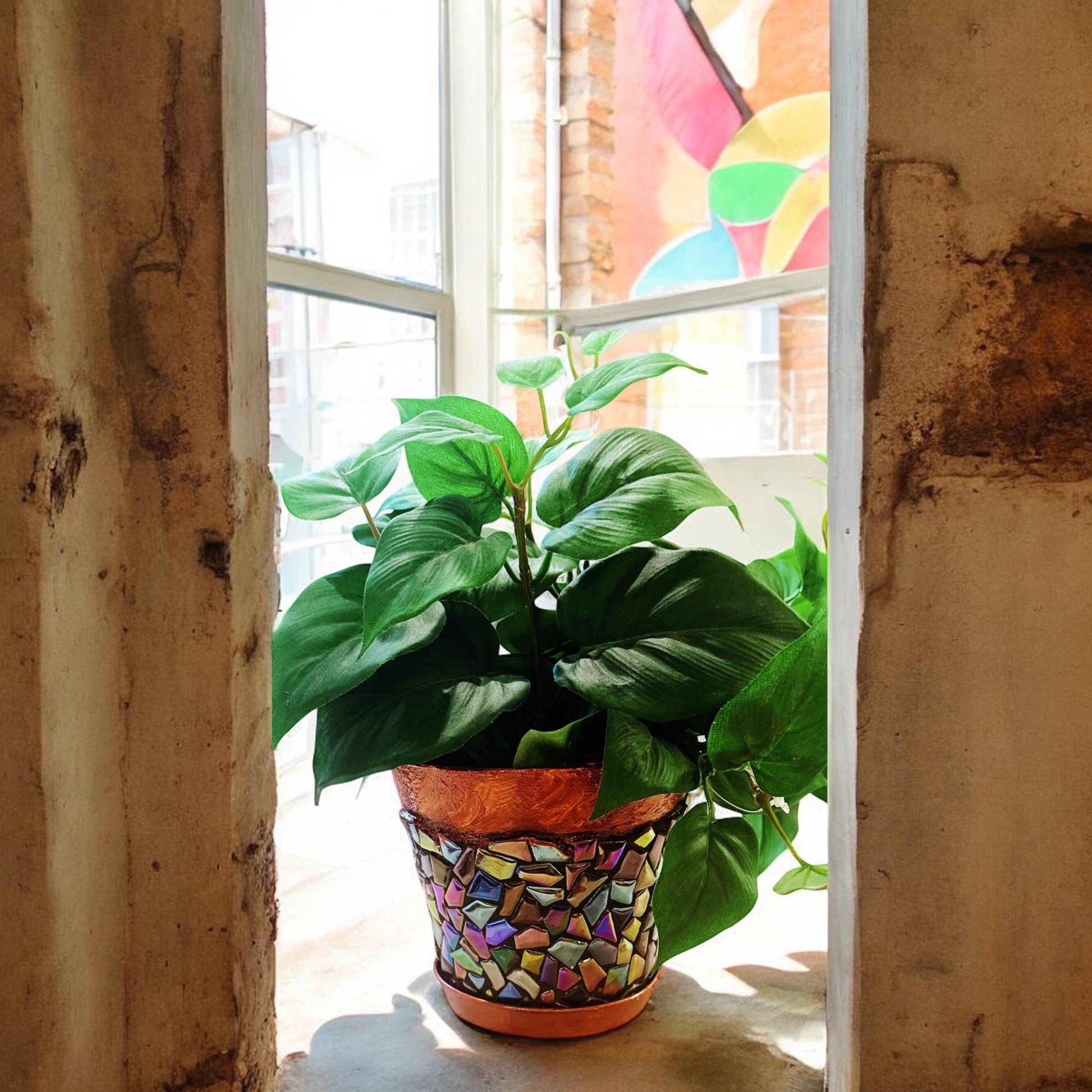 Iridescent mosaic planter with handcrafted design, showcasing a colorful, reflective surface perfect for indoor or outdoor plants.