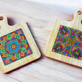 Handcrafted diamond art wood cutting board with intricate design, made from polished wood, ideal for kitchen use and display.