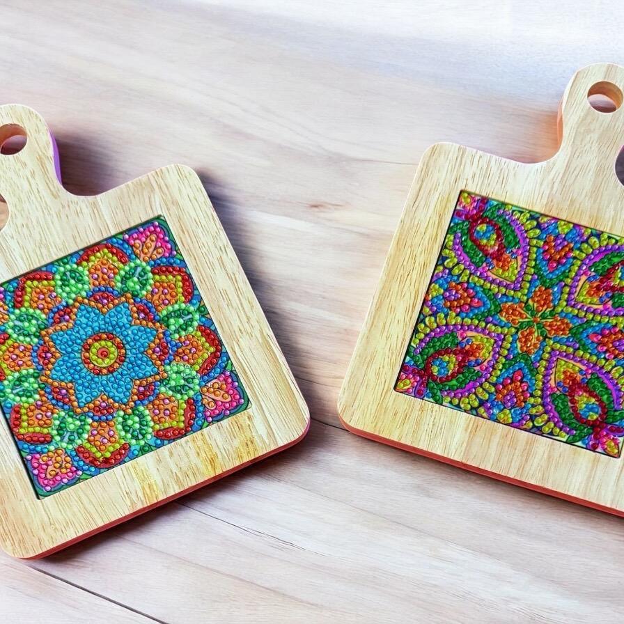 Handcrafted diamond art wood cutting board with intricate design, made from polished wood, ideal for kitchen use and display.