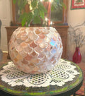 Handcrafted scalloped Capiz shell globe vase with intricate design, perfect for elegant home decor.