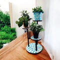 Three-tier mosaic multi-level plant stand with colorful tile design, perfect for displaying indoor or outdoor potted plants.