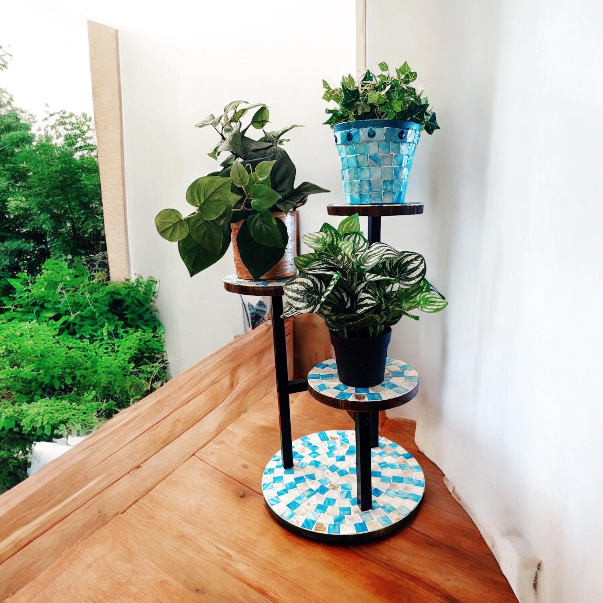 Three-tier mosaic multi-level plant stand with colorful tile design, perfect for displaying indoor or outdoor potted plants.