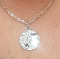 Vintage initial charm necklace with a gold chain and engraved initial pendant, stylish accessory for everyday wear.