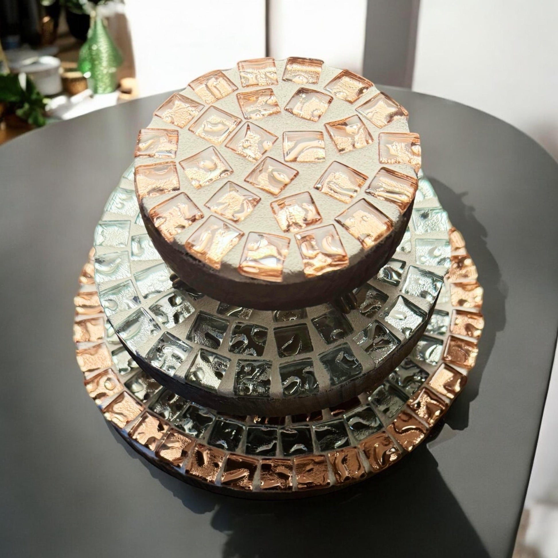 Set of handcrafted metallic mosaic plant stands featuring colorful, intricate designs for indoor or outdoor use.