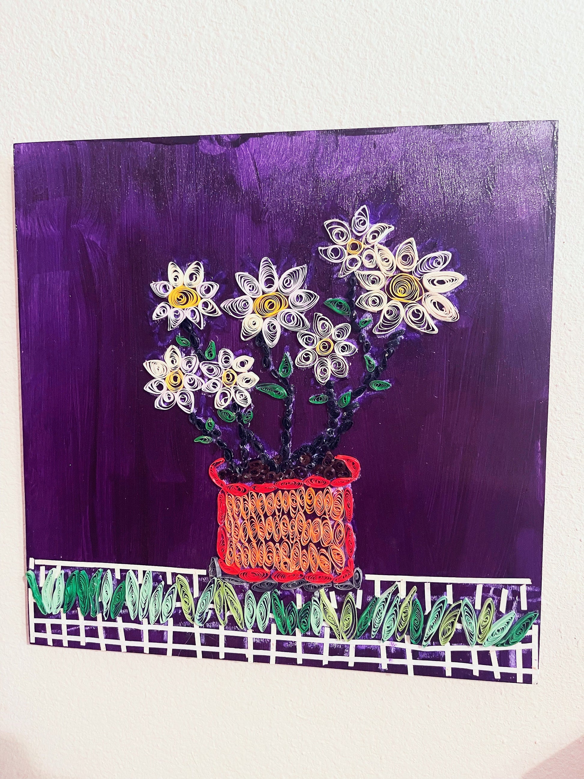 Original paper quilling art of a flower pot, showcasing intricate floral designs on a white background.