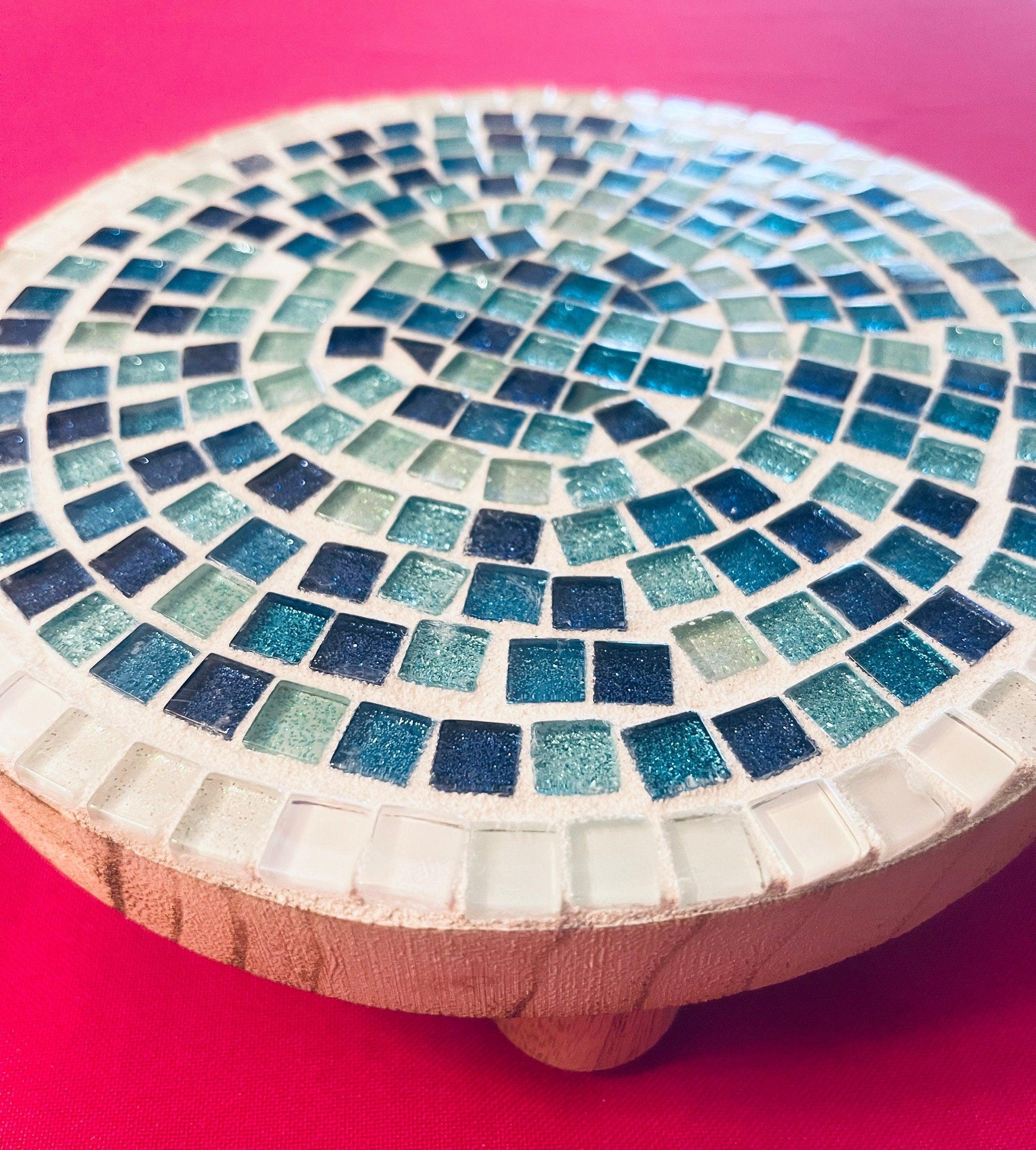 Handcrafted round turquoise glass mosaic plant riser with intricate tile design, perfect for elevating potted plants.