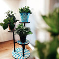 Three-tier azure mosaic plant stand with decorative ceramic tiles and metal frame, perfect for displaying plants indoors or outdoors.