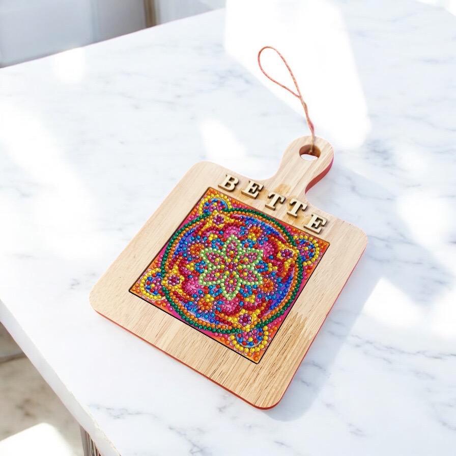 Handcrafted diamond art wood cutting board with intricate design, made from natural wood, ideal for kitchen use and decorative display.