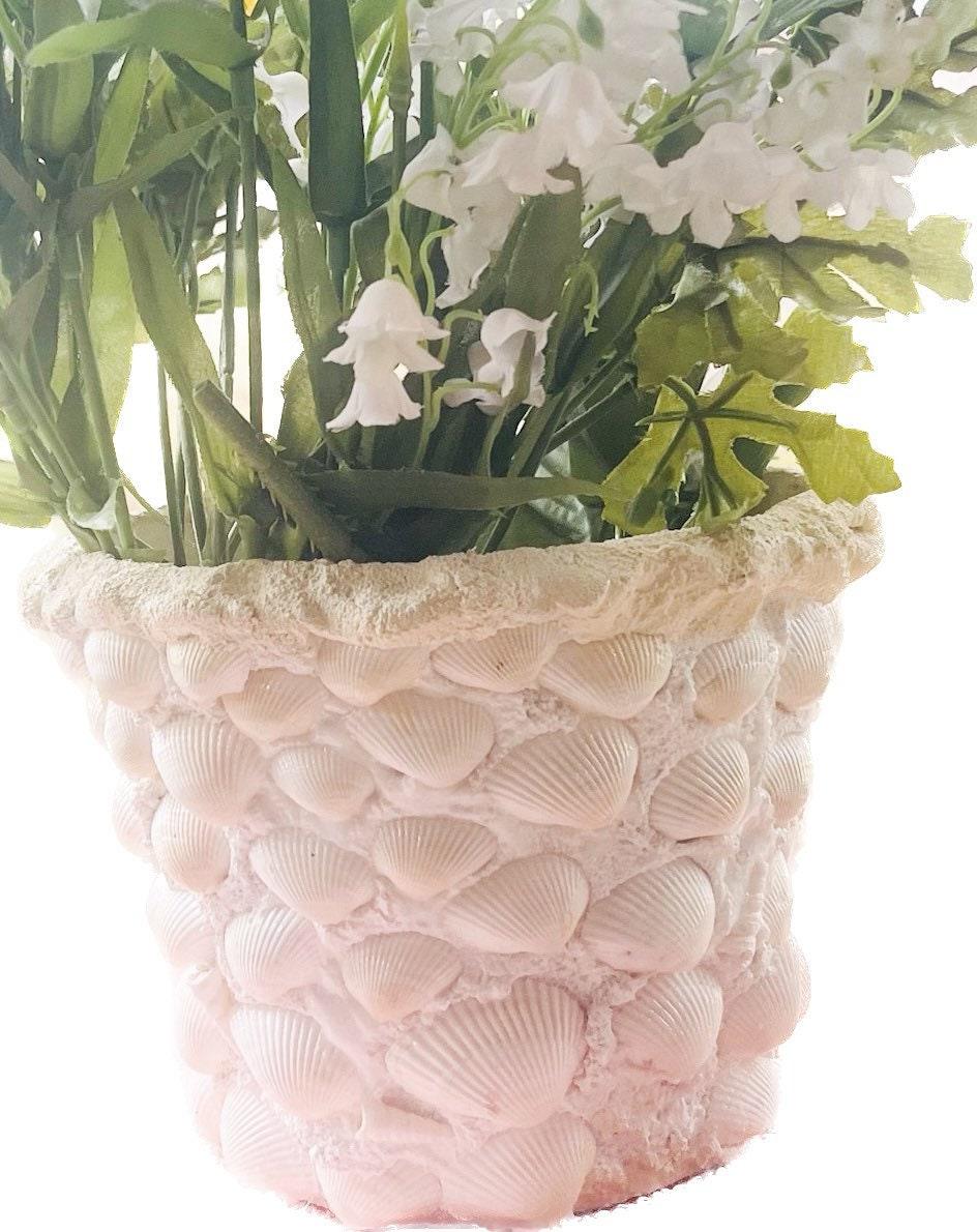 Handcrafted seashell mosaic plant pot with colorful seashells and intricate design, perfect for indoor or outdoor decor.