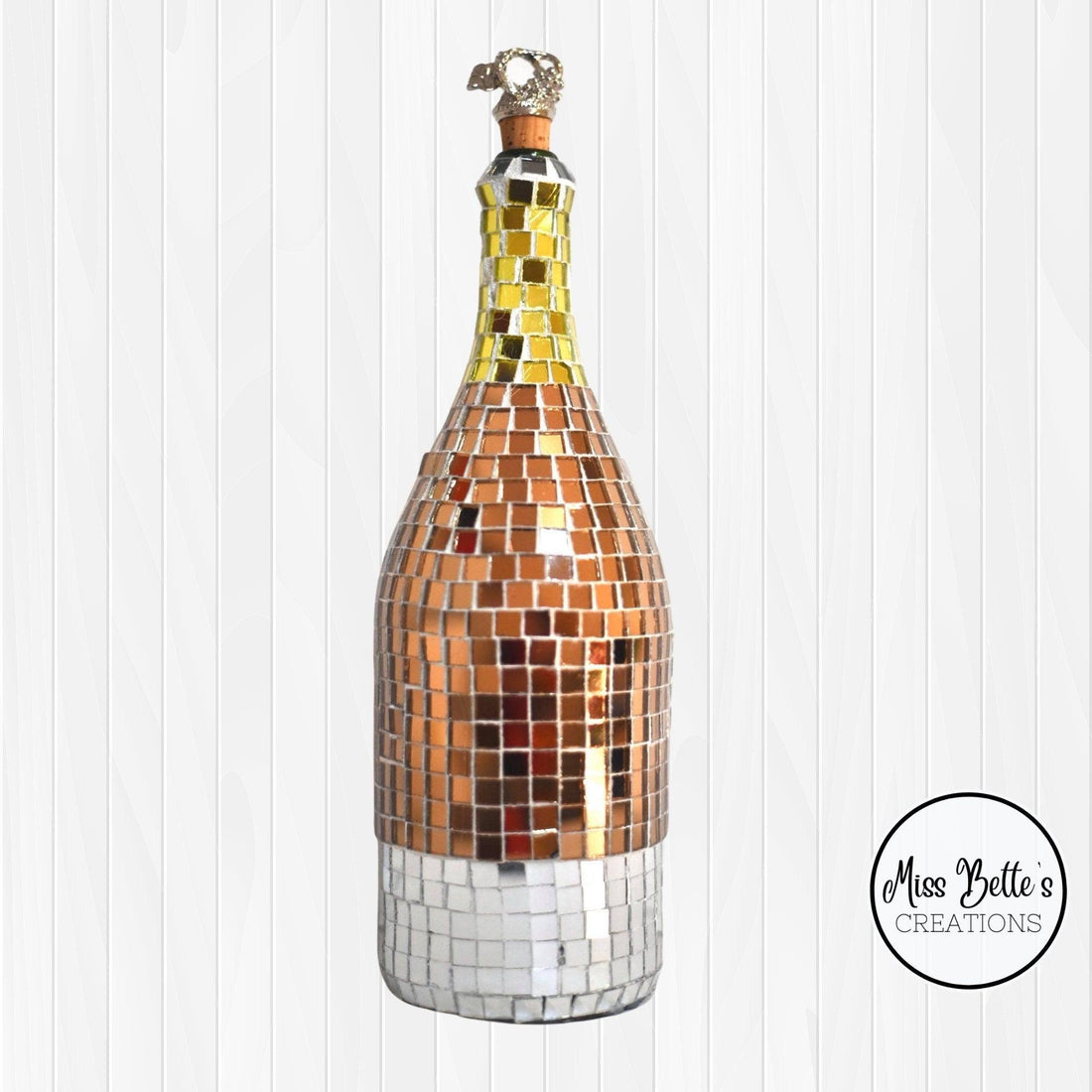 Elegant gold mosaic wine decanter with intricate design, perfect for showcasing and serving wine in a luxurious style.
