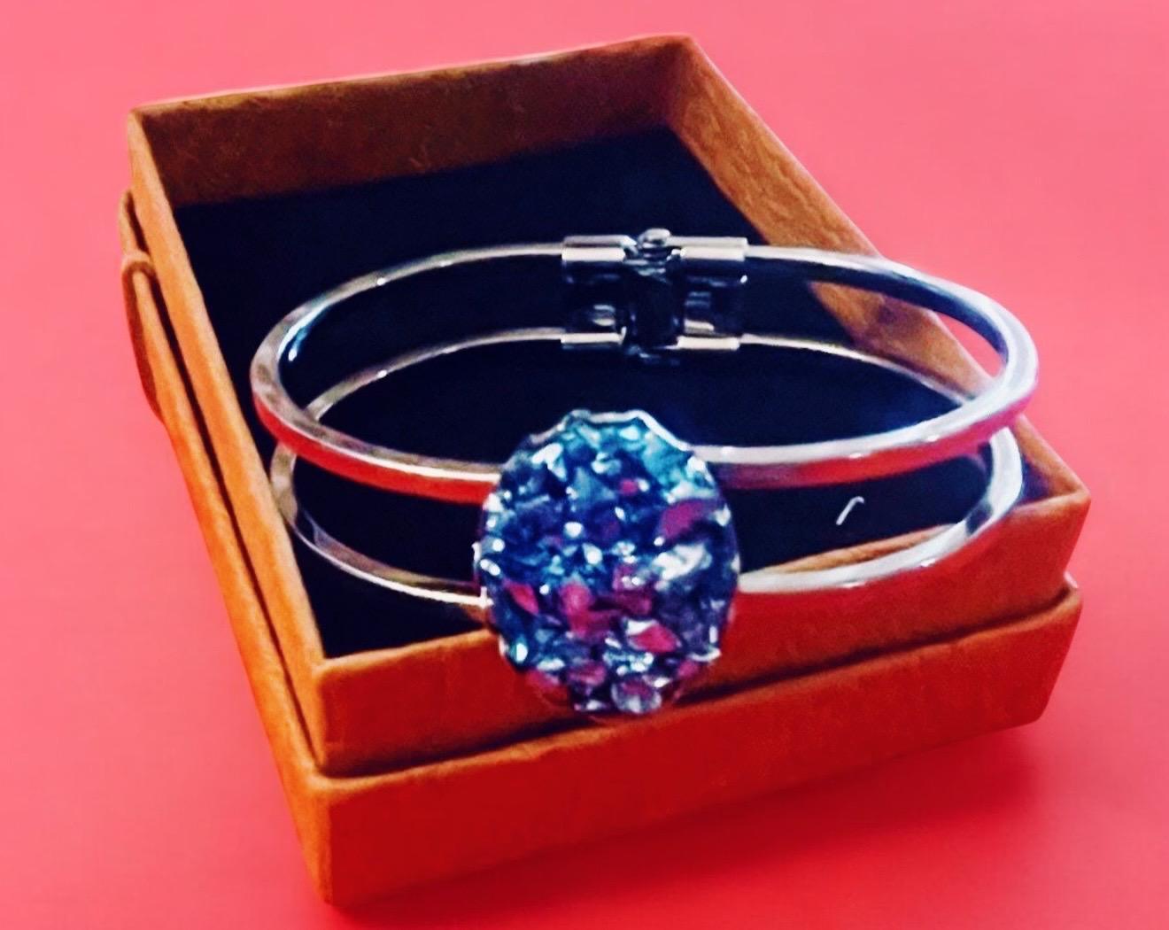Deep blue glass cuff bracelet with smooth, rounded edges, showcasing a stylish and modern jewelry design.