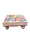 Square multicolored shell plant stand with open design and vibrant shell accents, perfect for displaying potted plants.