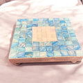 Square turquoise mother of pearl plant stand, handcrafted with a detailed design, perfect for displaying potted plants.
