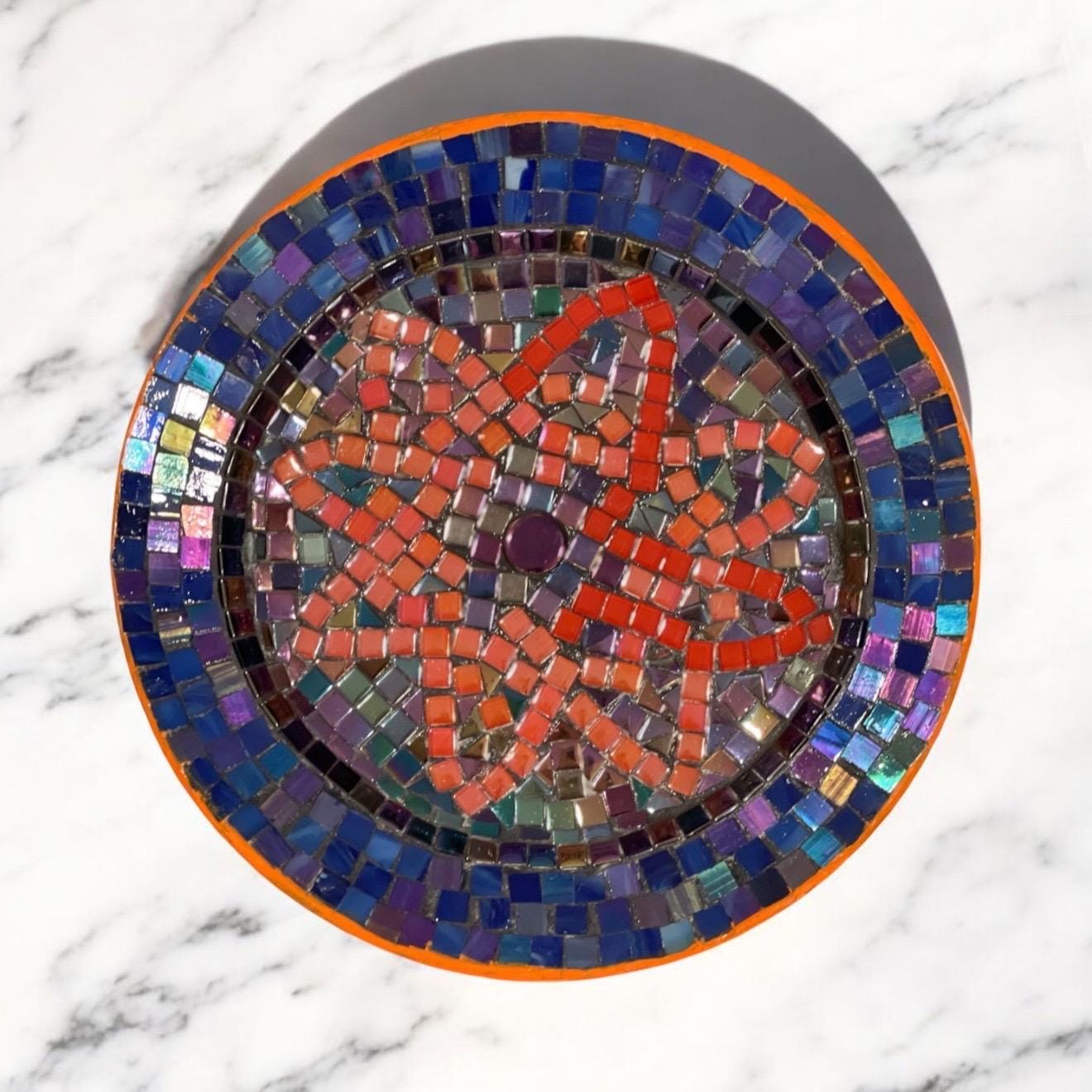 Handcrafted round mosaic wall art featuring colorful glass tiles, ideal for decorative home wall decor.