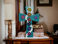 Colorful handcrafted mosaic cross with intricate tile details, showcasing vibrant patterns and craftsmanship.