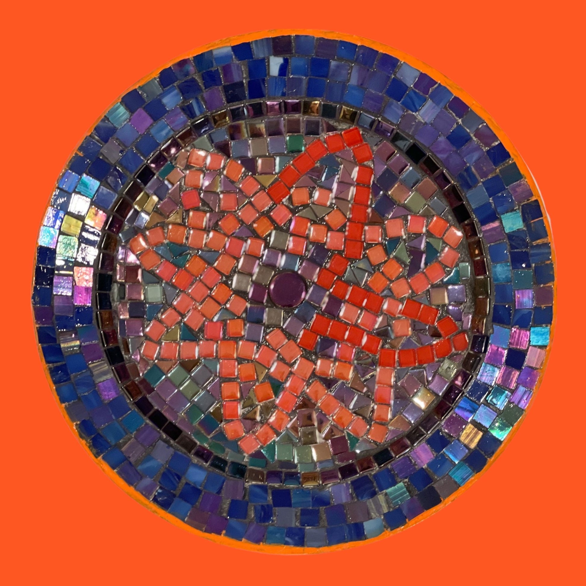 Handcrafted round mosaic wall art featuring colorful glass tiles, perfect for decorative home wall accents.