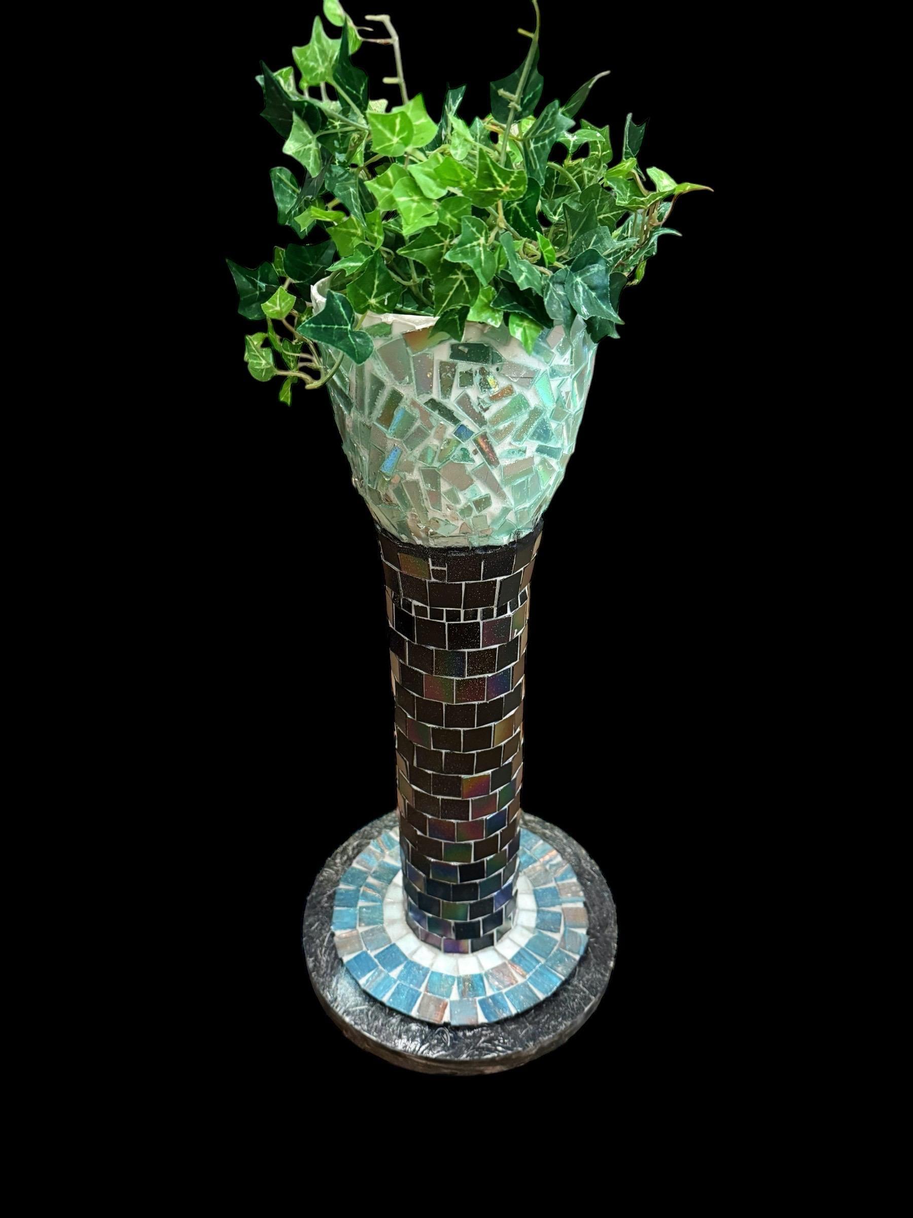 Colorful handcrafted mosaic pedestal planter with intricate tile patterns, perfect for indoor or outdoor decorative plant displays.