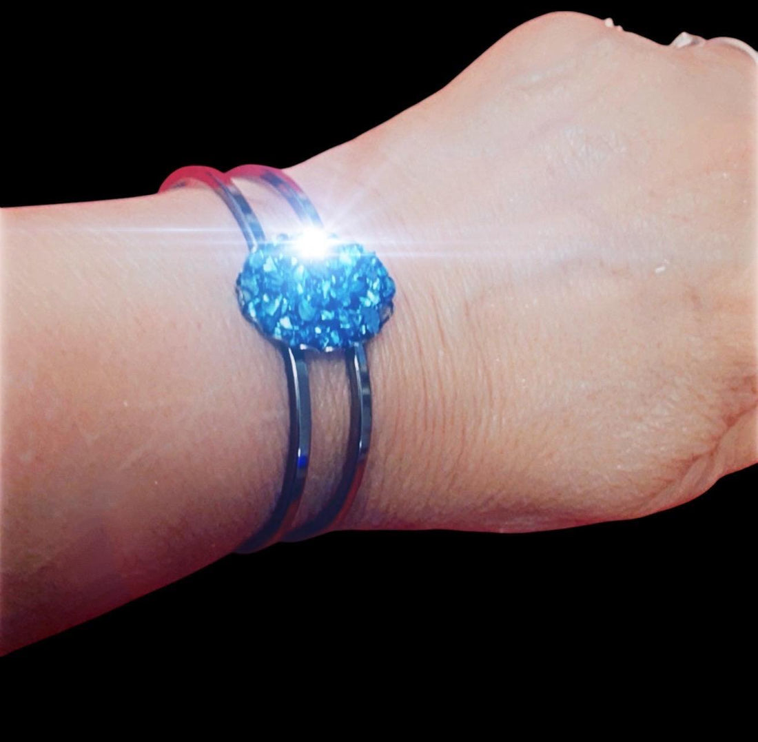Deep blue glass cuff bracelet with smooth, rounded edges, showcasing a stylish and modern jewelry design.