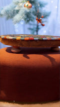 Butterfly crystal mosaic trivet with decorative display featuring colorful glass and intricate butterfly design.