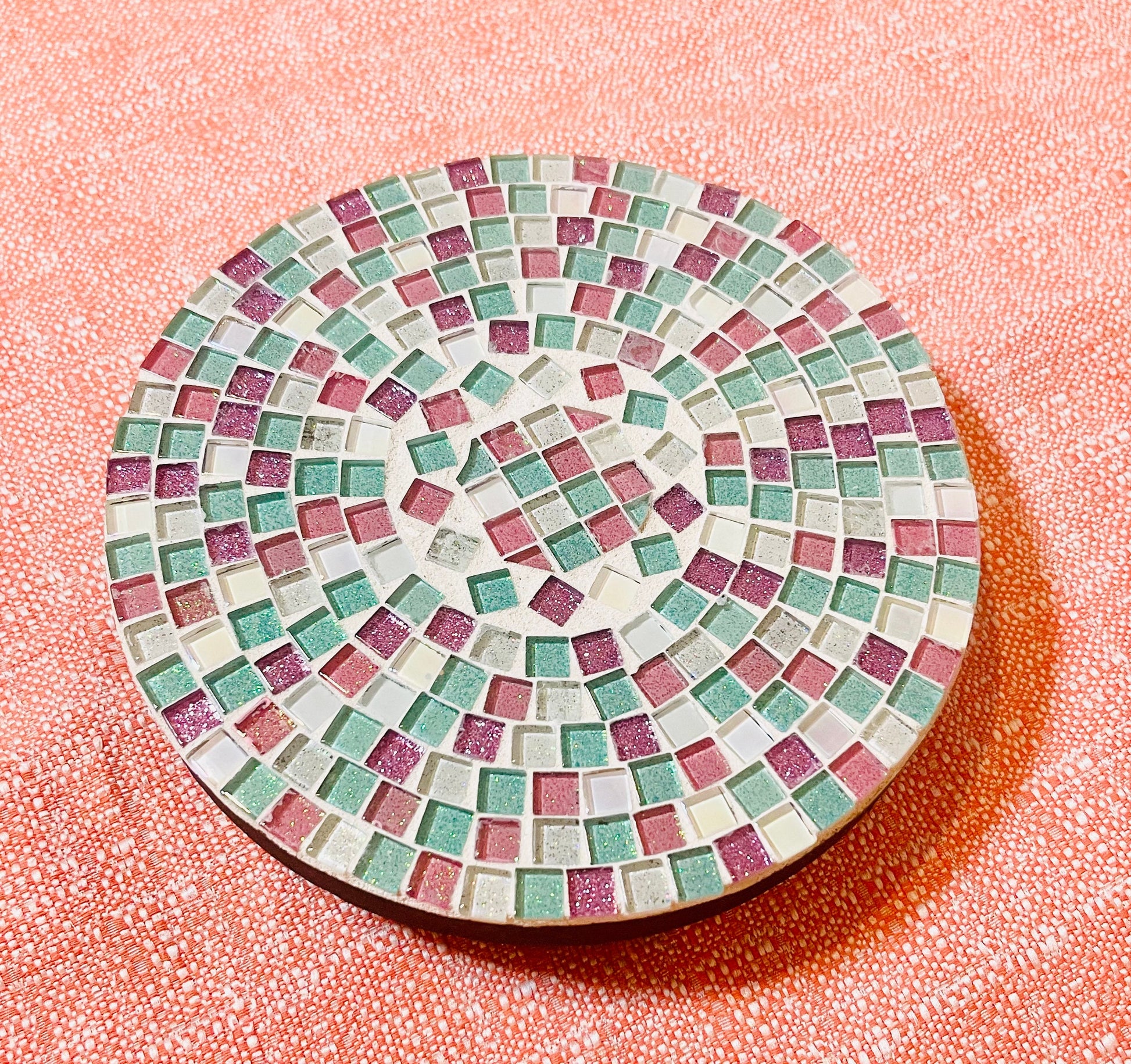 Handcrafted pink and green mosaic plant stand with decorative patterns, made by Miss Bette's Creations.