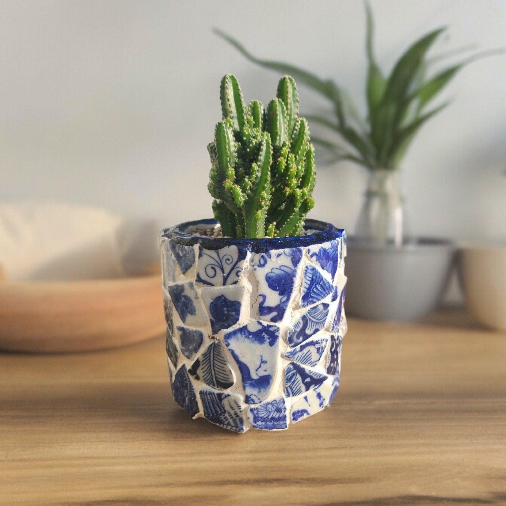 White broken china mosaic planter with intricate mosaic pattern, perfect for adding decorative greenery to indoor or outdoor spaces.