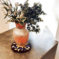 Blue and white petal mosaic wooden plant stand with a handcrafted design, perfect for showcasing potted plants.