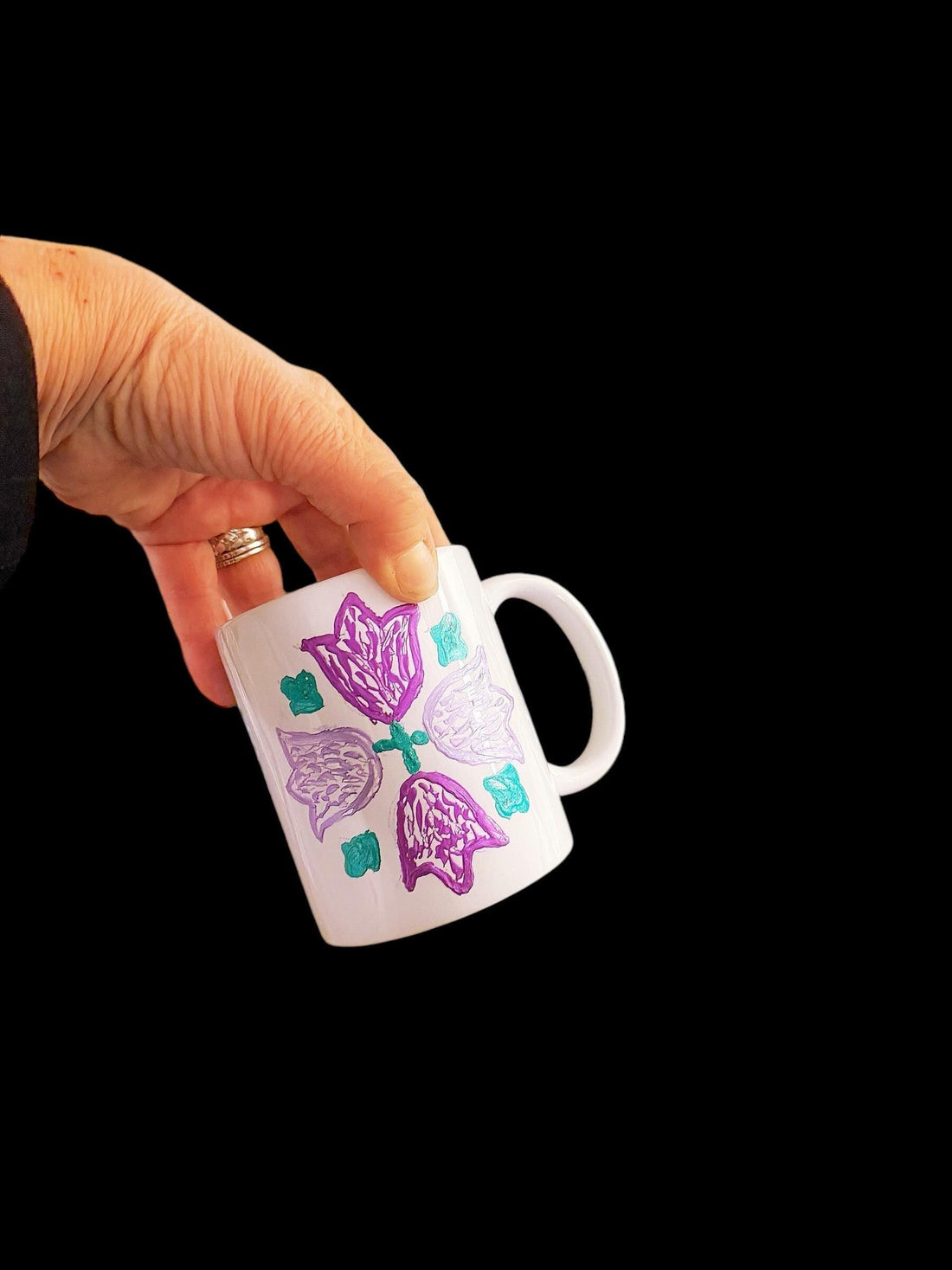 Colorful handpainted coffee mugs with floral designs from My Store, showcasing vibrant patterns on ceramic mugs.