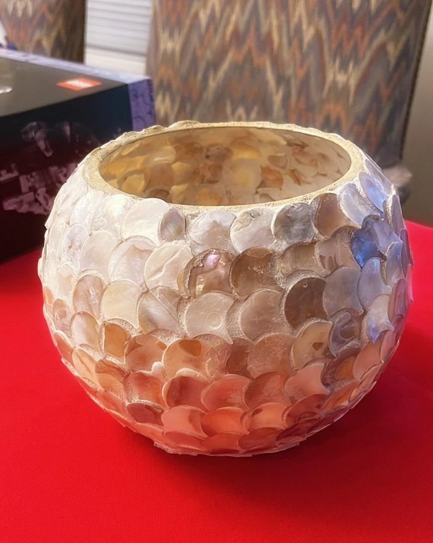 Handcrafted scalloped Capiz shell globe vase featuring a transparent, decorative design with a rounded shape and intricate shell pattern.