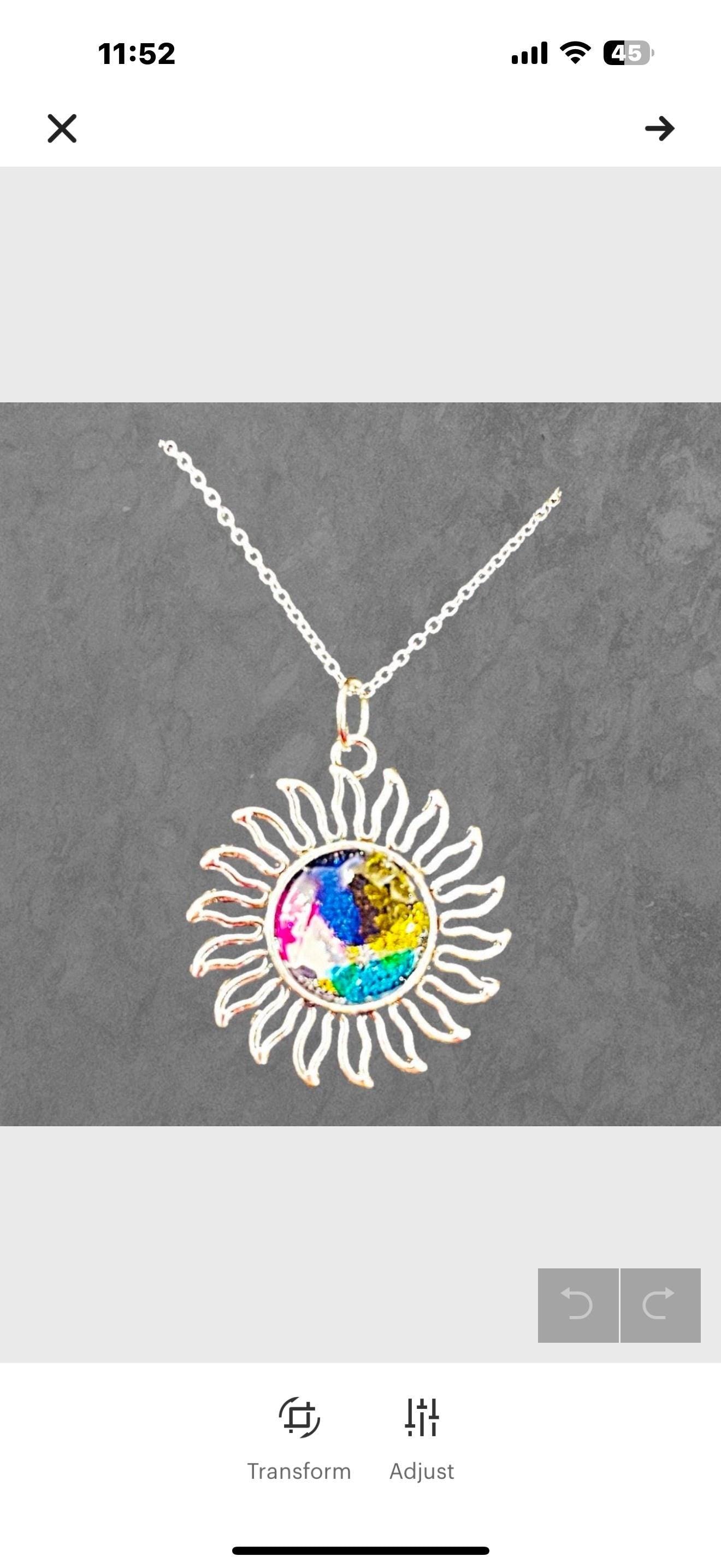 Multicolored glass sunburst pendant necklace with silver chain, featuring vibrant stained glass design, from My Store.