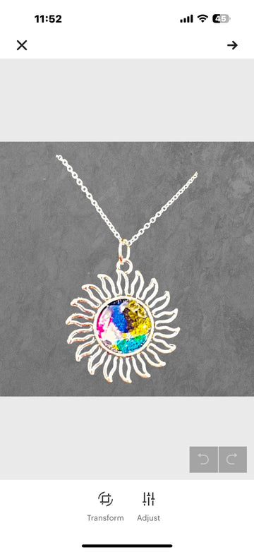 Multicolored glass sunburst pendant necklace with silver chain, featuring vibrant stained glass design, from My Store.