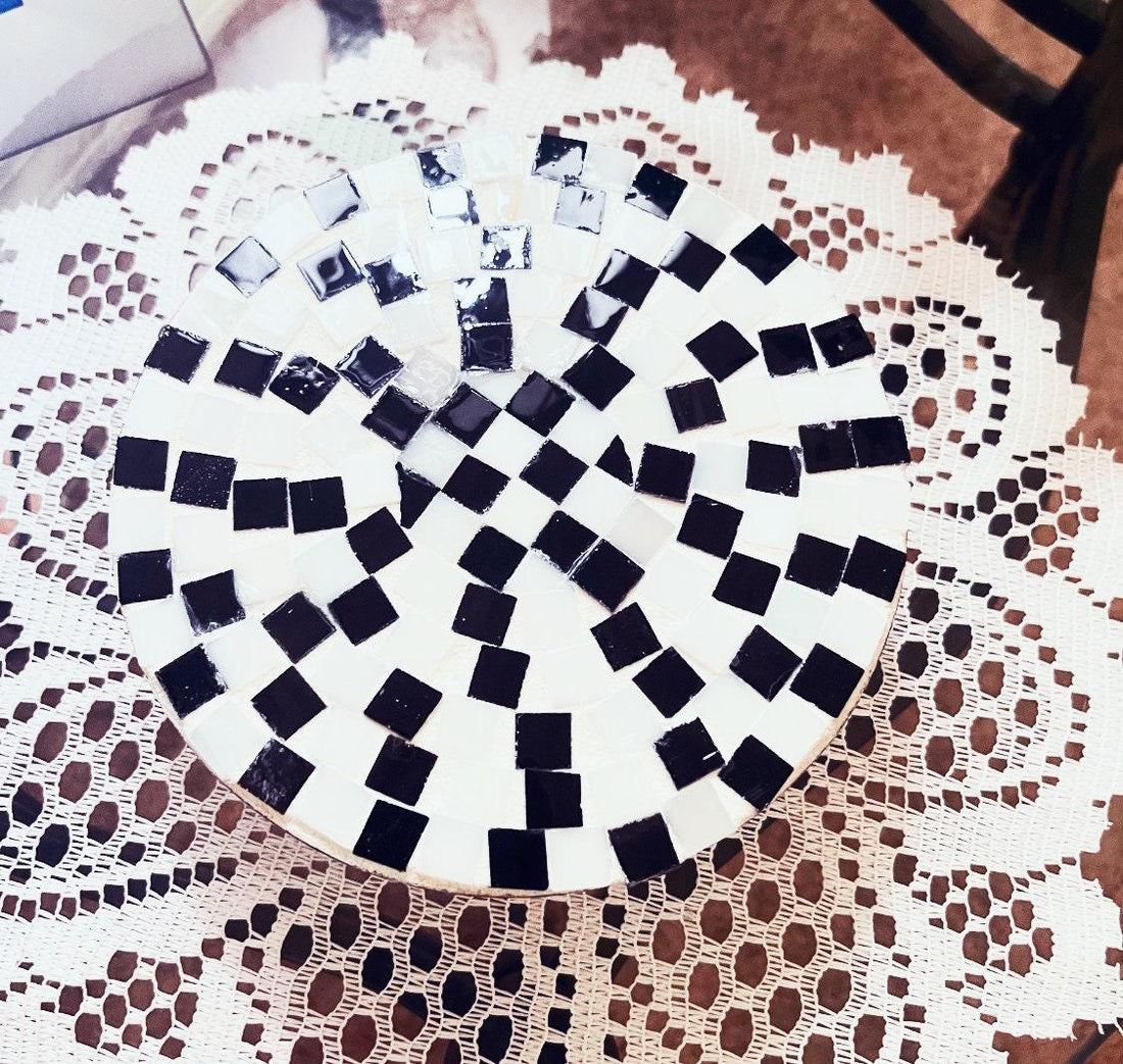 Handmade black and white checkered mosaic plant stand with sturdy design, perfect for displaying potted plants indoors.