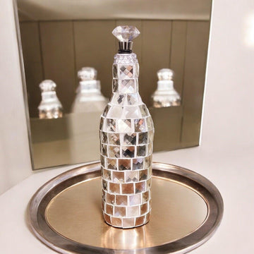 Silver mirrored mosaic wine decanter with intricate mosaic design, showcasing its reflective surface and elegant shape.