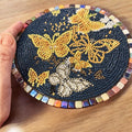 Butterfly crystal mosaic trivet with decorative display featuring colorful glass and intricate butterfly design on a wooden surface.