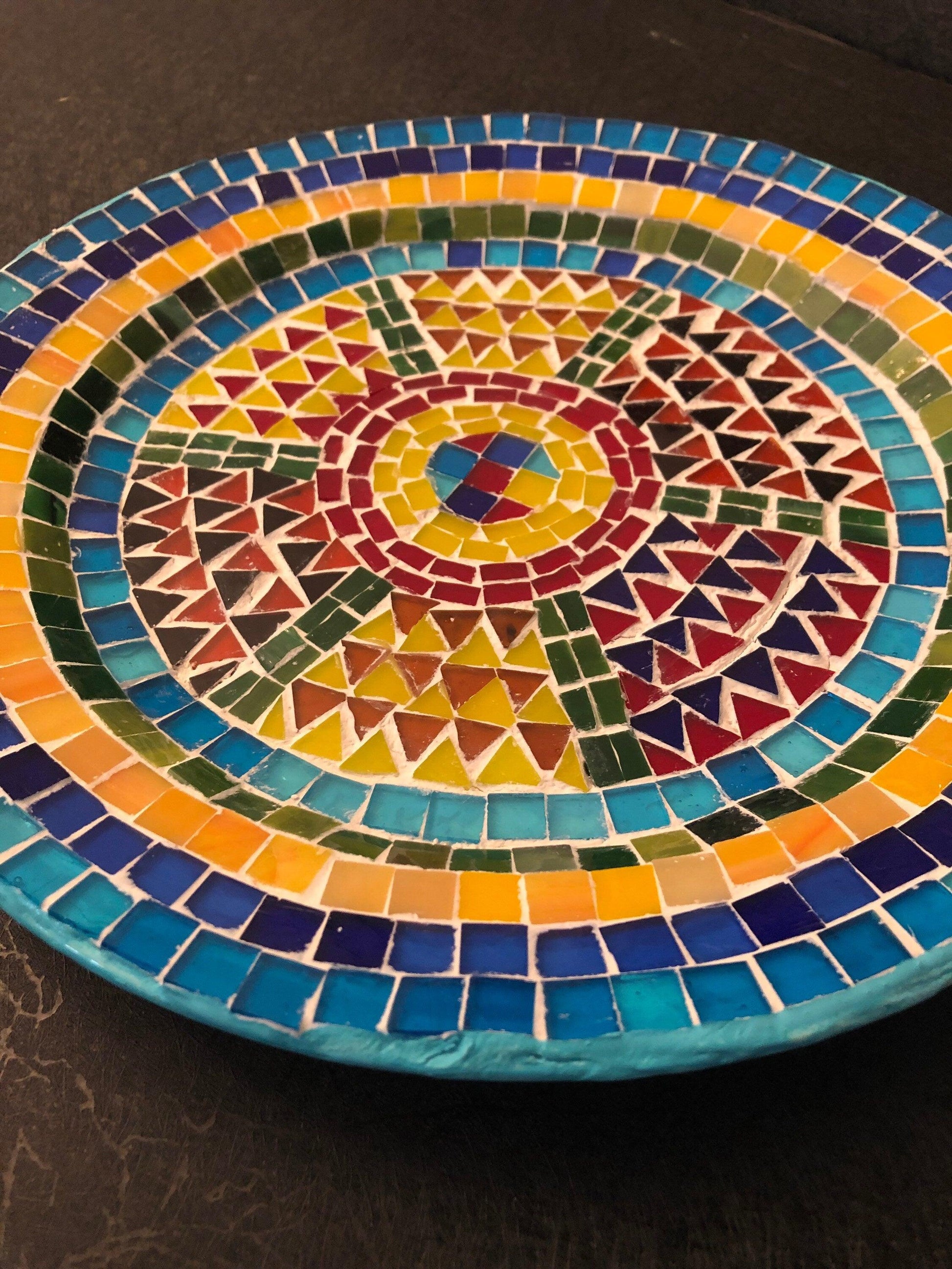 Handmade geometric mosaic plant plate with colorful tile patterns, ideal for decorative indoor or outdoor plant displays.