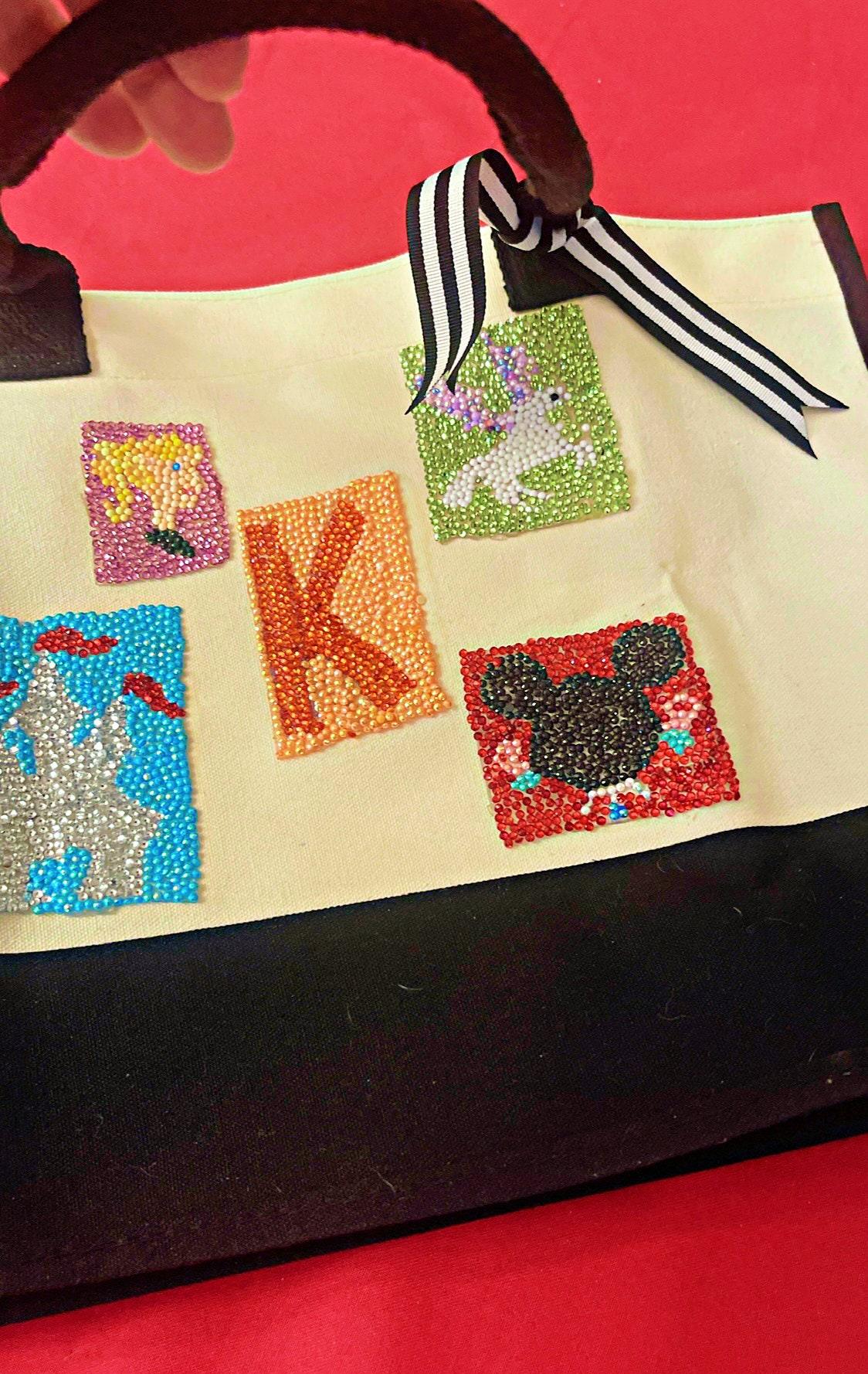 Handmade "K" initial fairy tale diamond art tote bag with colorful diamond accents, featuring a whimsical design and sturdy handles.