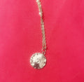 Vintage initial charm necklace featuring a personalized letter pendant on a delicate chain, stylish jewelry accessory.