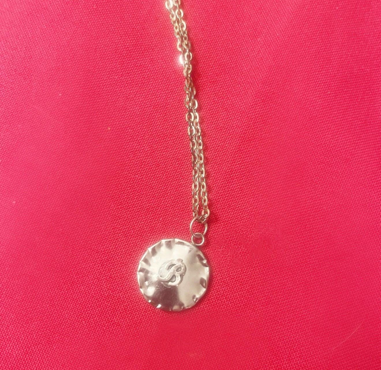 Vintage initial charm necklace featuring a personalized letter pendant on a delicate chain, stylish jewelry accessory.