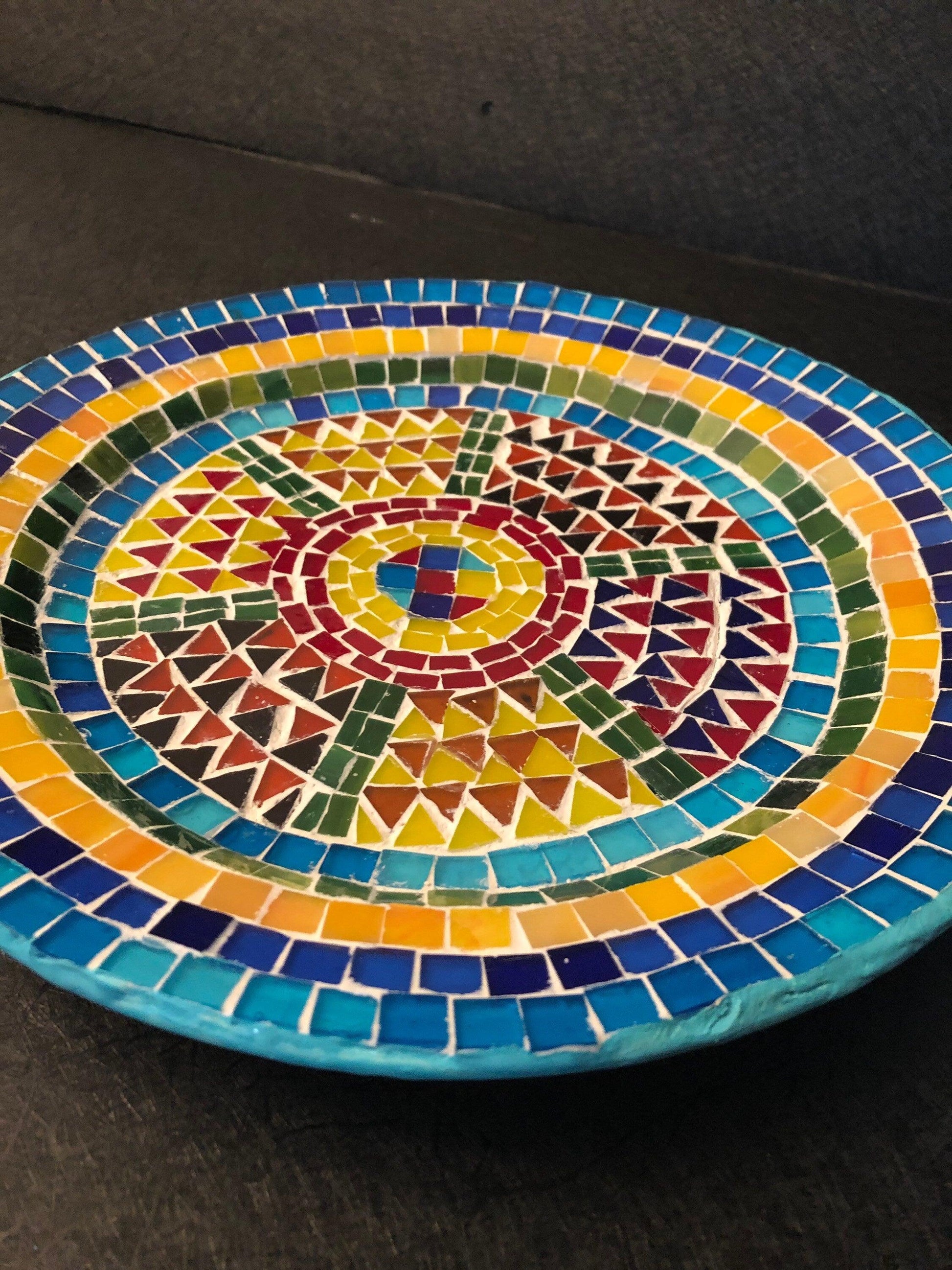 Handmade geometric mosaic plant plate with colorful tile patterns, perfect for displaying potted plants or as decorative kitchenware.