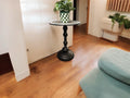 Round side table with iridescent gray and purple mosaic top on black metal base, 15-inch diameter and 20-inch height.