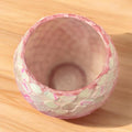 Handcrafted pink and scalloped mosaic bowl with an ombre gradient, showcasing intricate tile patterns and vibrant colors.
