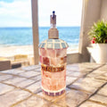 Handmade iridescent mother of pearl mosaic soap with shimmering, colorful shell pieces on a white background.