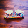 Ceramic trivet, spoon rest, and plant stand in white with decorative design, ideal for kitchen or table use.