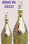 Luxury gold mosaic wine decanter with intricate design and elegant shape, perfect for serving wine in style.