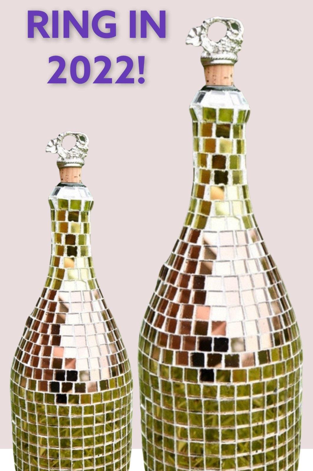 Luxury gold mosaic wine decanter with intricate design and elegant shape, perfect for serving wine in style.