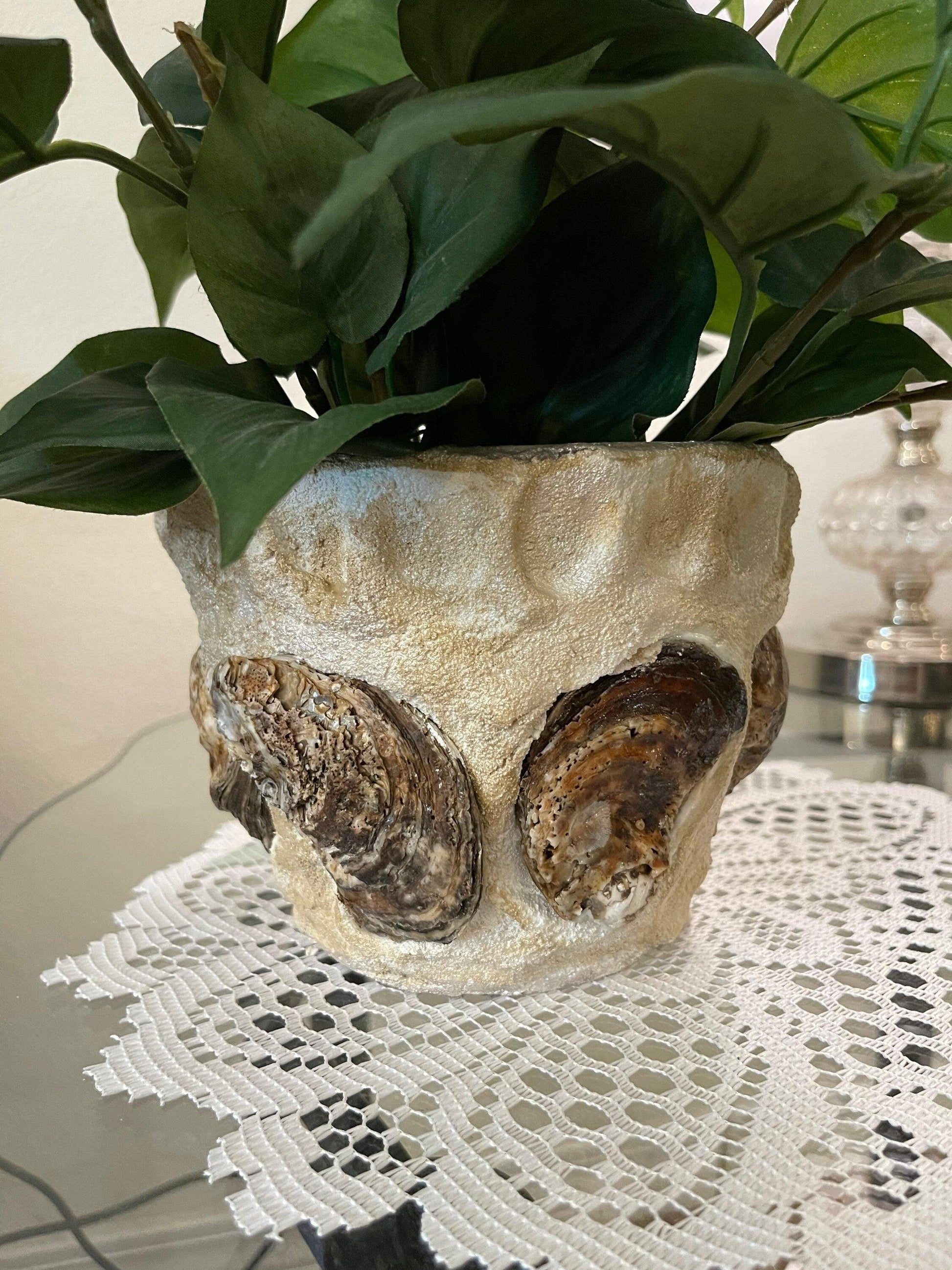 Handcrafted oyster shell relief planter with natural textures and earthy tones, ideal for coastal or rustic decor.