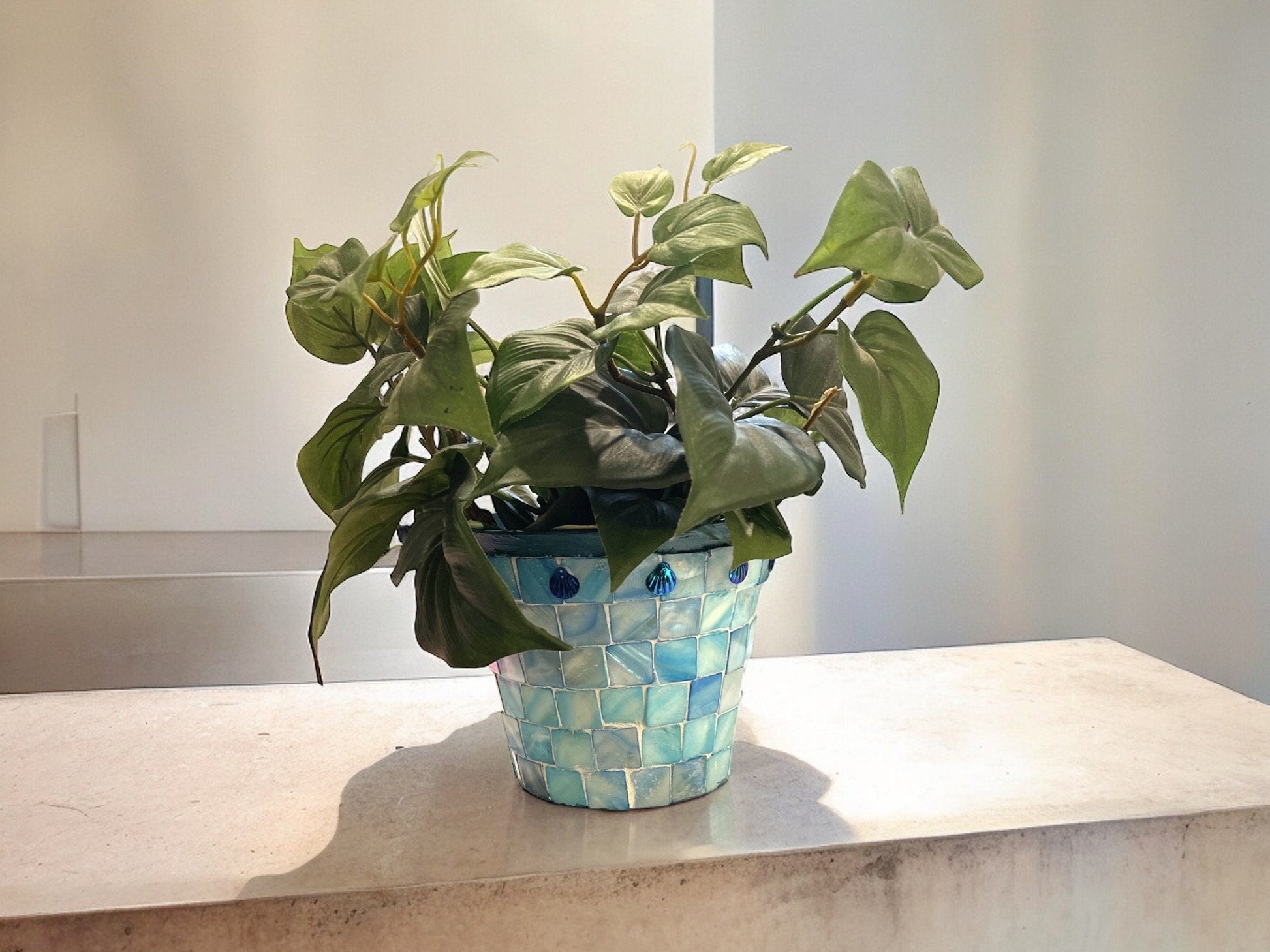 Artisan teal mosaic planter with mother of pearl accents by Miss Bette's Creations, showcasing intricate tile design and craftsmanship.