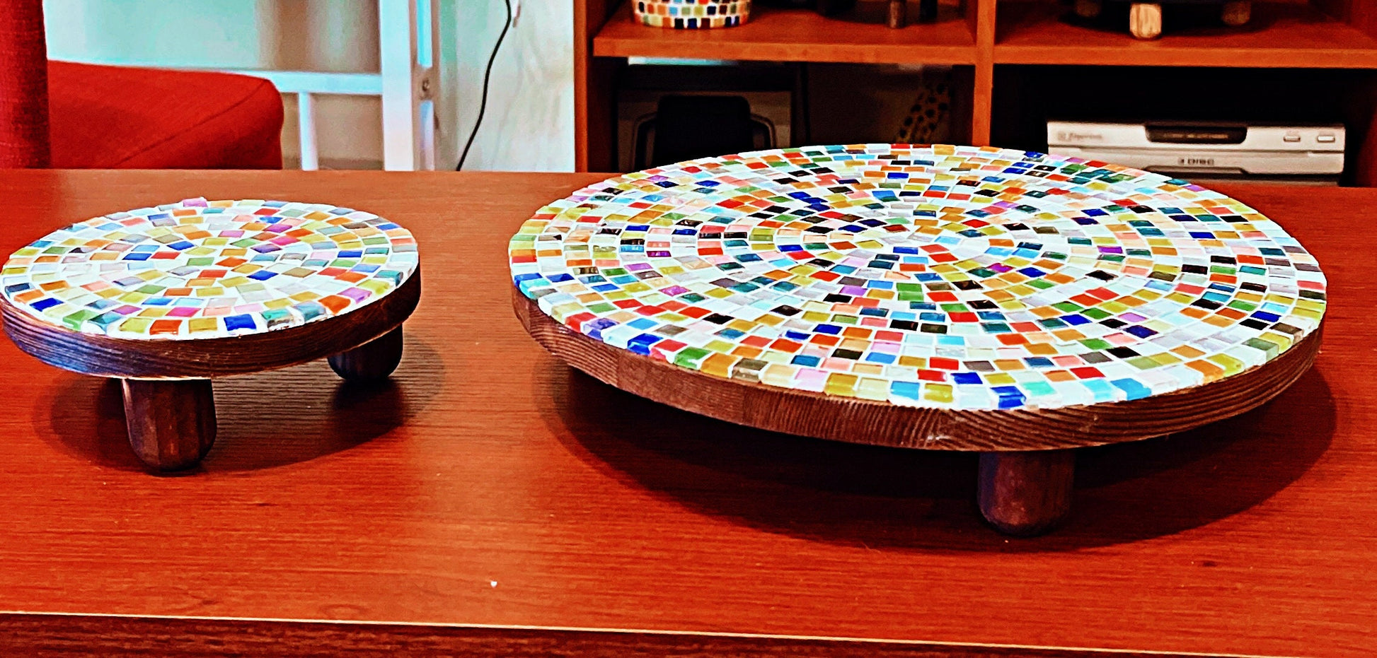 Handcrafted round rainbow mosaic plant stand with colorful glass tiles and sturdy metal frame, ideal for indoor greenery display.