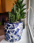 White broken china mosaic planter with intricate design, perfect for indoor or outdoor plant display.